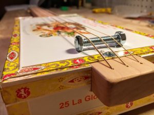 place the bolt bridge on the cigar box lid