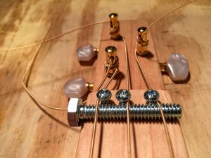 strings over the nut and under the string retainers