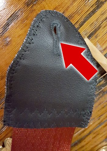 The slits in the ends of guitar straps are designed to go over strap buttons.