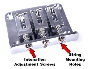 This chrome 3-string hard-tail bridge is a top-loading variety. Note the string holes visible beneath the adjustment screws. Available from CBGitty.com.