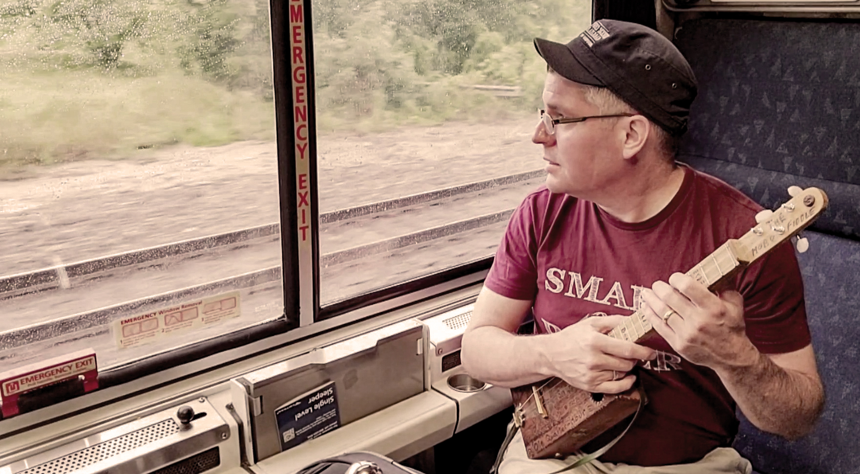 Ben Gitty Baker playing his Hobo Fiddle on an Amtrak Train.